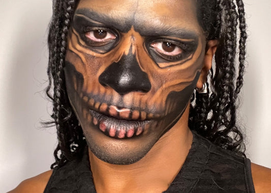 Content creator Jakobe Jay wears skeleton Halloween makeup using Milk Makeup Hydro Grip Primer and Milk Makeup Infinity Long Wear Eyeliner