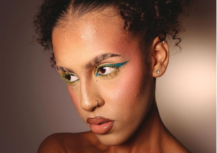 Model wears a colorful makeup look for holiday makeup inspiration